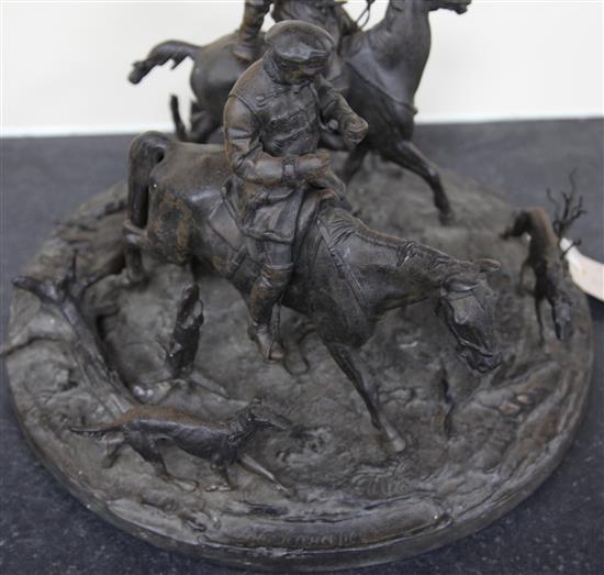 A 19th century Russian cast iron group of two huntsmen and five hounds, width 15in. height 11in.